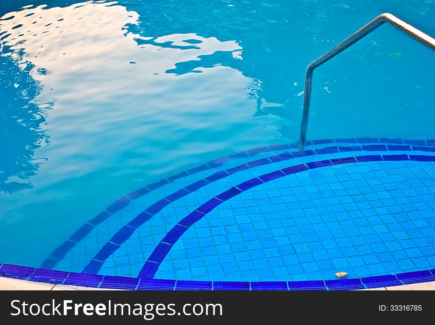 Luxury Resort Swimming Pool high angle on curved edge of a luxury resort swimming pool. Luxury Resort Swimming Pool high angle on curved edge of a luxury resort swimming pool