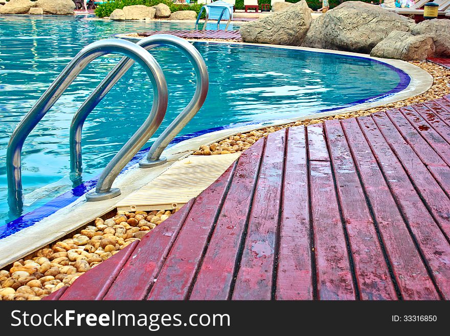 Luxury Resort Swimming Pool high angle on curved edge of a luxury resort swimming pool. Luxury Resort Swimming Pool high angle on curved edge of a luxury resort swimming pool