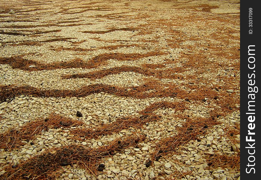 Needles waves on gravel, abstract background