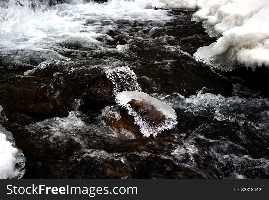 Small pieces of ice in the mountain river as jewels