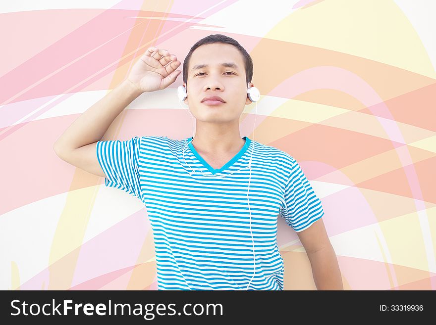 Asian Man Posing With Colorful Background  And Listening To Music. Asian Man Posing With Colorful Background  And Listening To Music