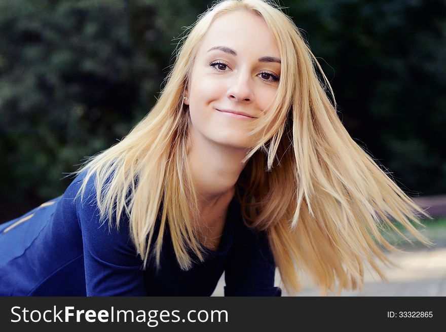 The girl waves long white hair. The girl waves long white hair