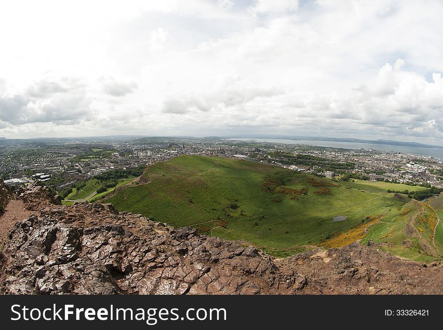 Arthur's Seat is the main peak of the group of hills which form most of Holyrood Park. It is situated in the centre of the city of Edinburgh, about a mile to the east of Edinburgh Castle. The hill rises above the city to a height of 250.5 m (822 ft), provides excellent panoramic views of the city, is relatively easy to climb, and is popular for hillwalking. Arthur's Seat is the main peak of the group of hills which form most of Holyrood Park. It is situated in the centre of the city of Edinburgh, about a mile to the east of Edinburgh Castle. The hill rises above the city to a height of 250.5 m (822 ft), provides excellent panoramic views of the city, is relatively easy to climb, and is popular for hillwalking.