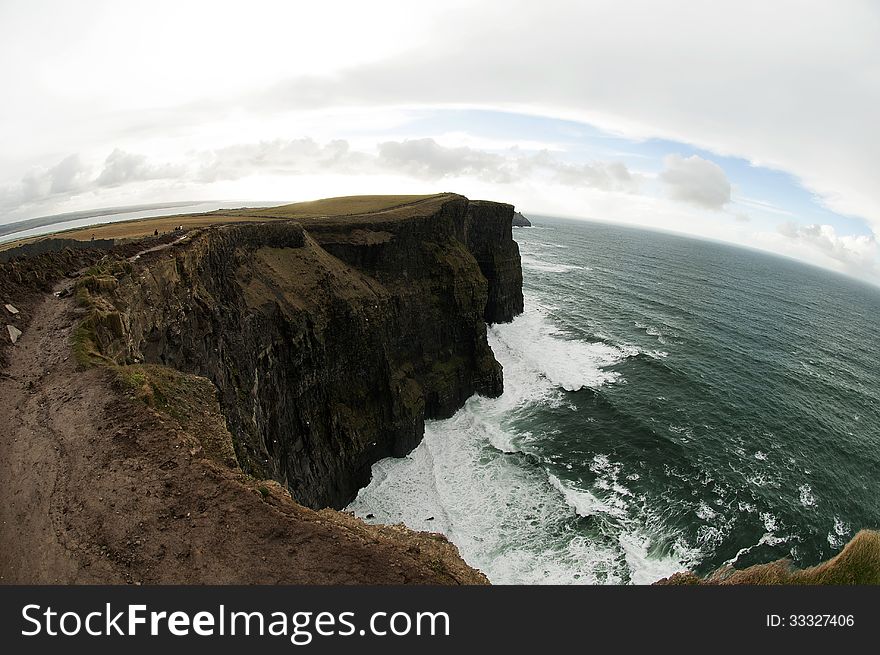 The Cliffs of Moher (Irish: Aillte an Mhothair) are located at the southwestern edge of the Burren region in County Clare, Ireland. They rise 120 metres (390 ft) above the Atlantic Ocean at Hag's Head, and reach their maximum height of 214 metres (702 ft) just north of O'Brien's Tower. The Cliffs of Moher (Irish: Aillte an Mhothair) are located at the southwestern edge of the Burren region in County Clare, Ireland. They rise 120 metres (390 ft) above the Atlantic Ocean at Hag's Head, and reach their maximum height of 214 metres (702 ft) just north of O'Brien's Tower.