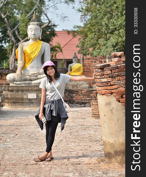 Beautiful young girl and buddha at Wat Yai Chai Mongkol Temple. Ayutthaya - Thailand
