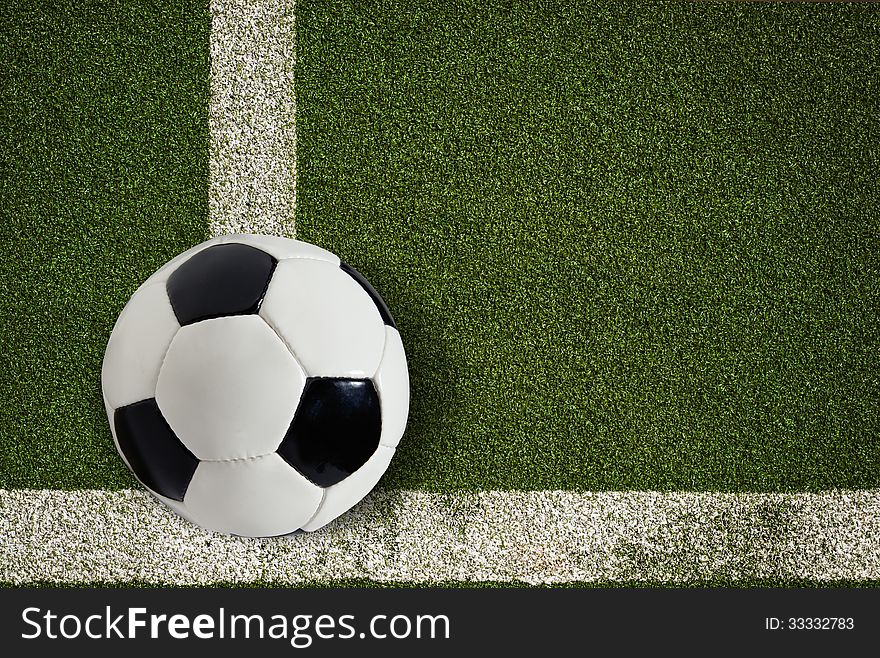 High resolution soccer ball on green field