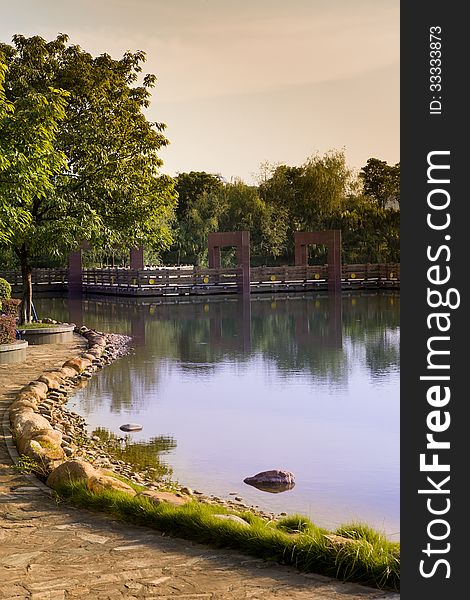 Autumn lake with a footbridge at sunset. Autumn lake with a footbridge at sunset