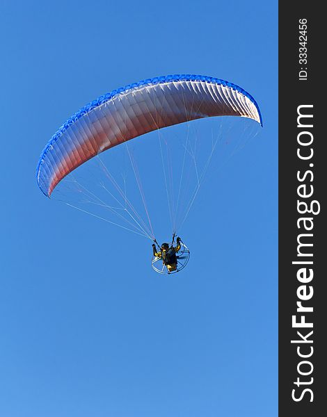 Parachute with the motor in the blue sky. Parachute with the motor in the blue sky