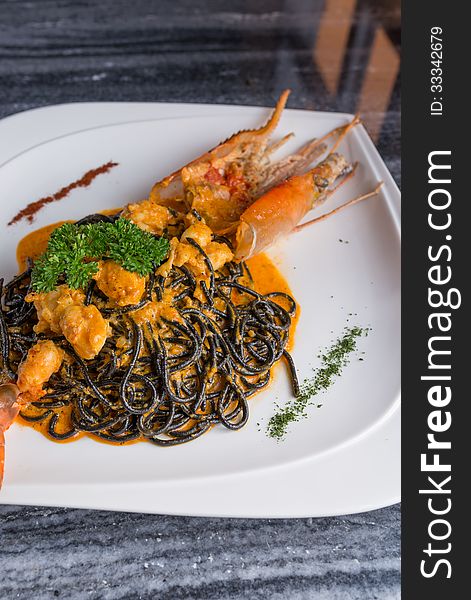 Grilled river prawn serve with black spaghetti. Grilled river prawn serve with black spaghetti