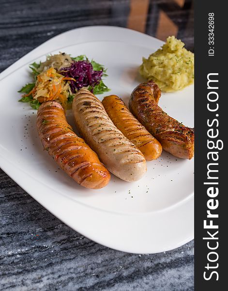 Variety of Germany sausages serve with mini salad