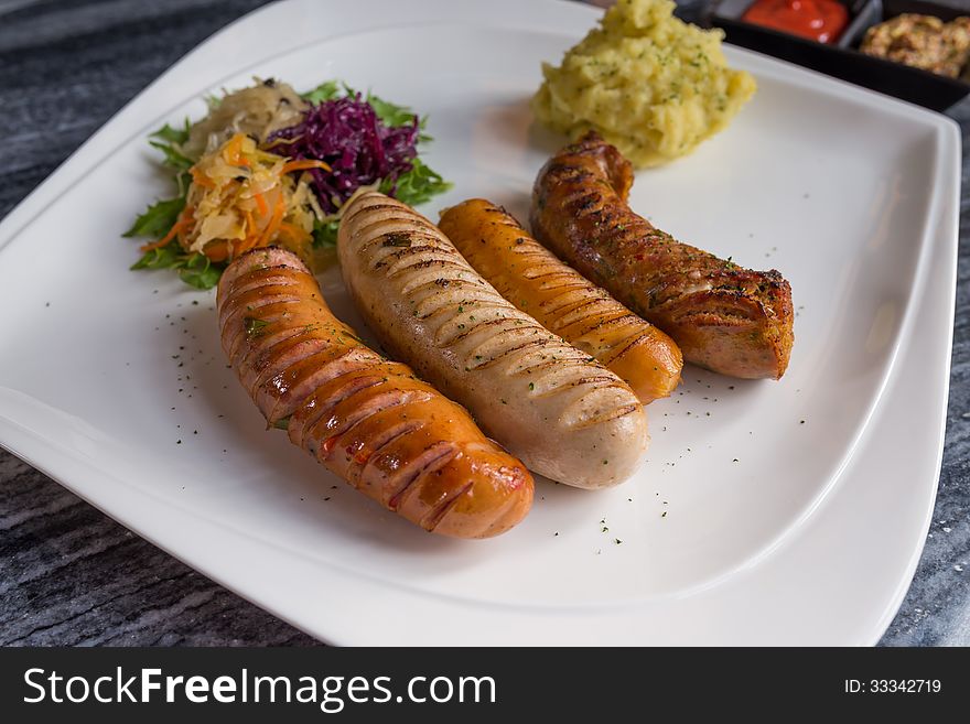 Variety of Germany sausages serve with mini salad