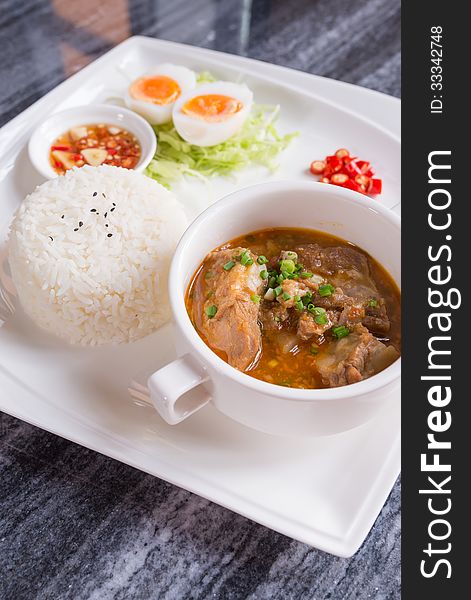 Dish set of steamed rice and chicken tom yam Thai traditional spicy soup. Dish set of steamed rice and chicken tom yam Thai traditional spicy soup