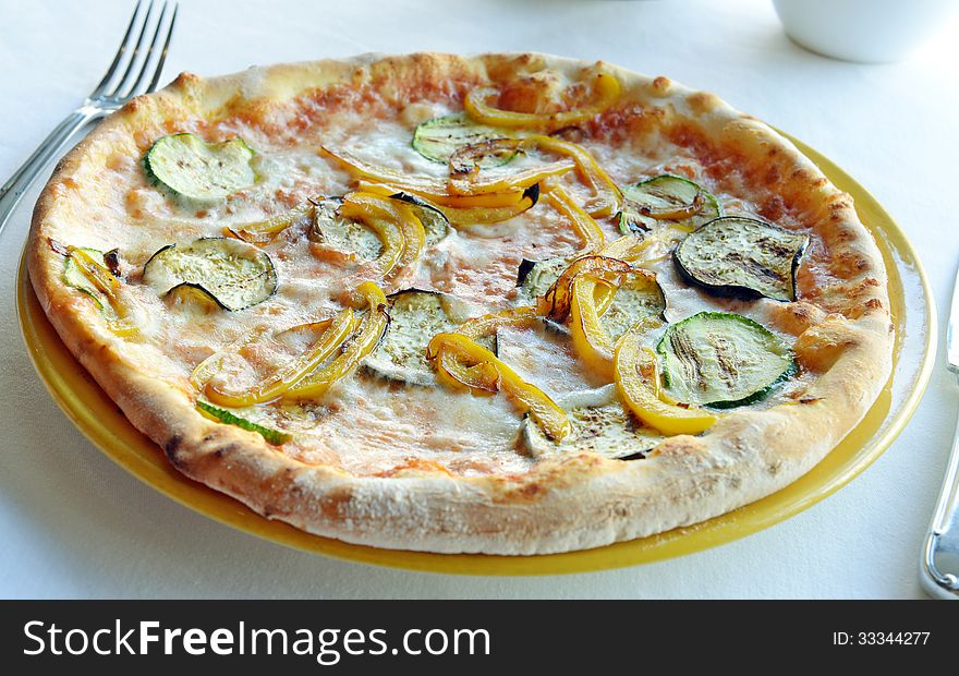 Vegetarian pizza with eggplant and peppers on a plate