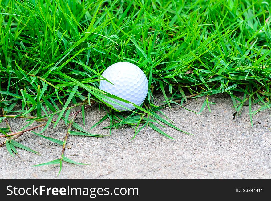 Golf ball out off fairway on cement a road