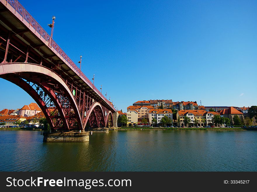 Lent and old bridge across the Drava river on sunny summer day, Maribor, Slovenia. Lent and old bridge across the Drava river on sunny summer day, Maribor, Slovenia