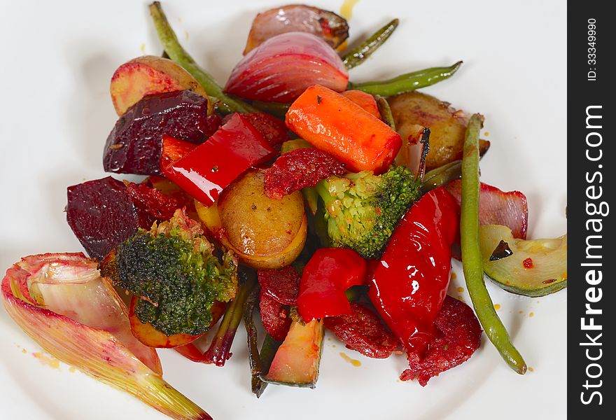 A closeup image of a white dinner plate with with different healthy vegetables. there are mushroom gravy, potatoes, red pepper, carrots, red beet, fennel, onions, green beans,zucchini, broccoli and a garnish. A closeup image of a white dinner plate with with different healthy vegetables. there are mushroom gravy, potatoes, red pepper, carrots, red beet, fennel, onions, green beans,zucchini, broccoli and a garnish.