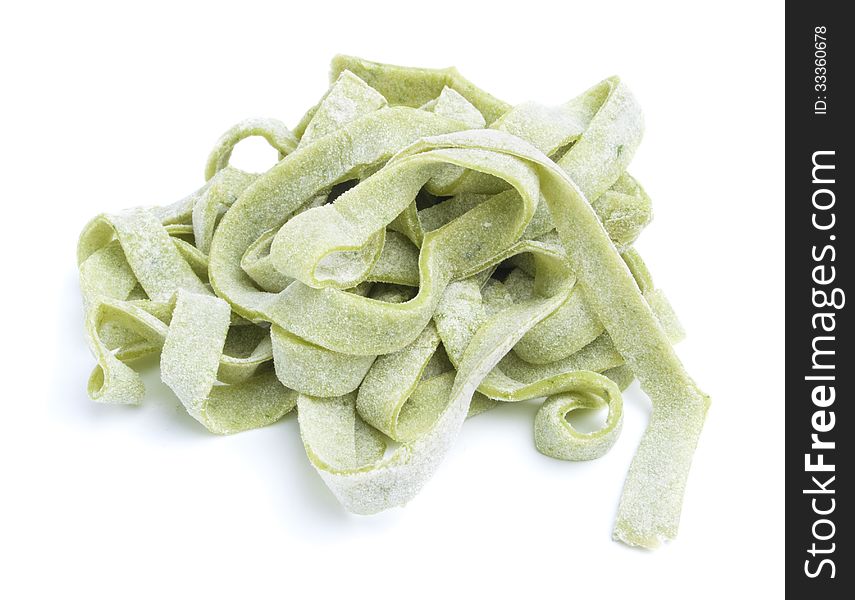 Fresh green tagliatelle pasta isolated on white