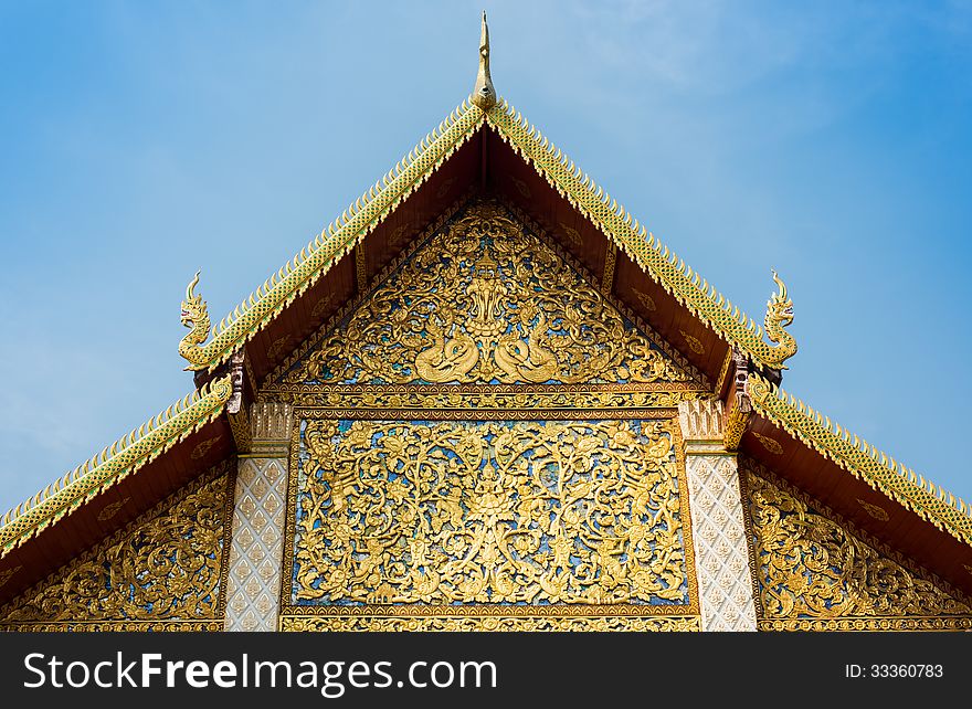 The roof gable or tympanum of temple in Lamphun Province, Thailand. The roof gable or tympanum of temple in Lamphun Province, Thailand