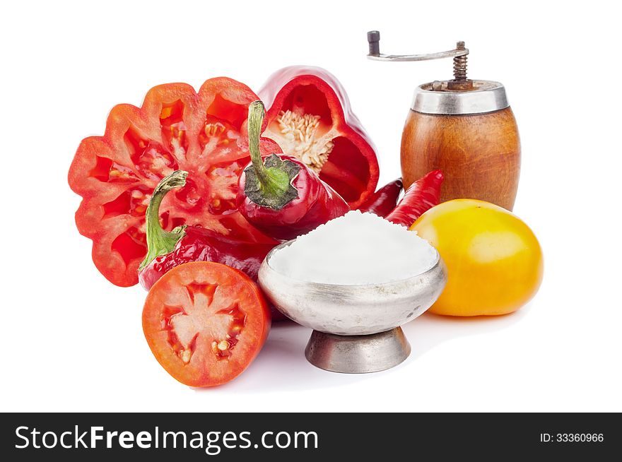 Tomatoes, peppers and salt isolated on white. Tomatoes, peppers and salt isolated on white