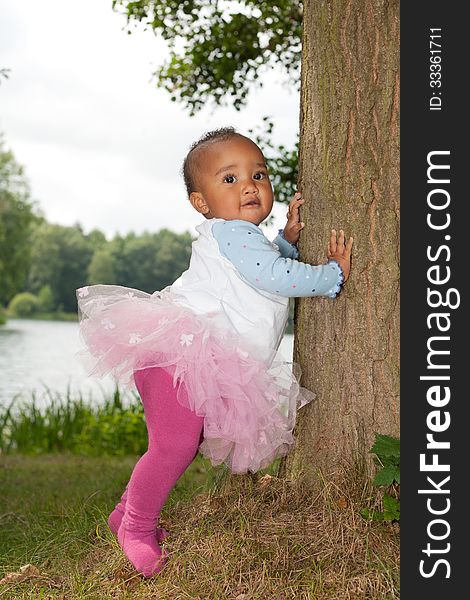 African Little Girl Is Holding The Tree