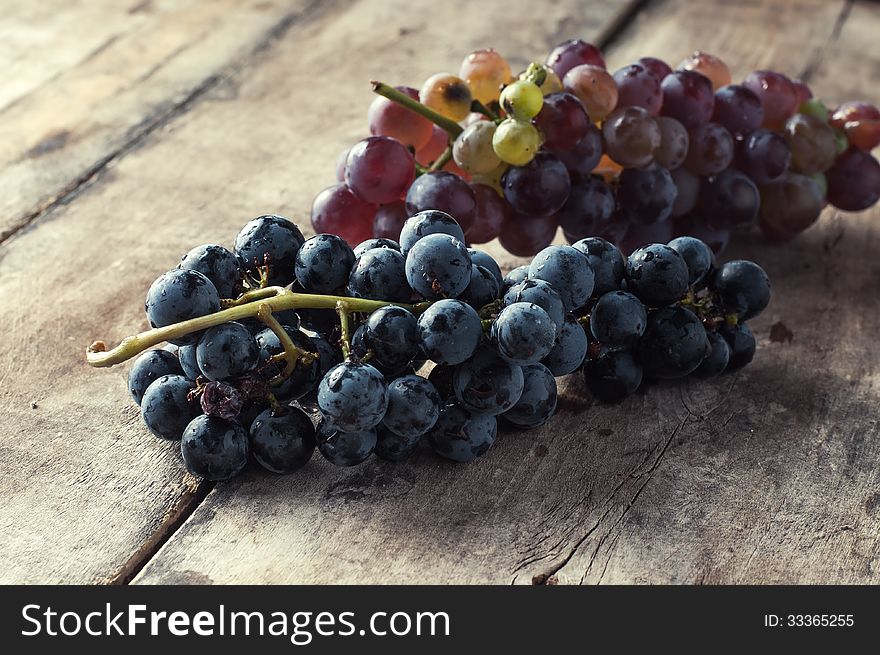 Grapes on a old wooden table.