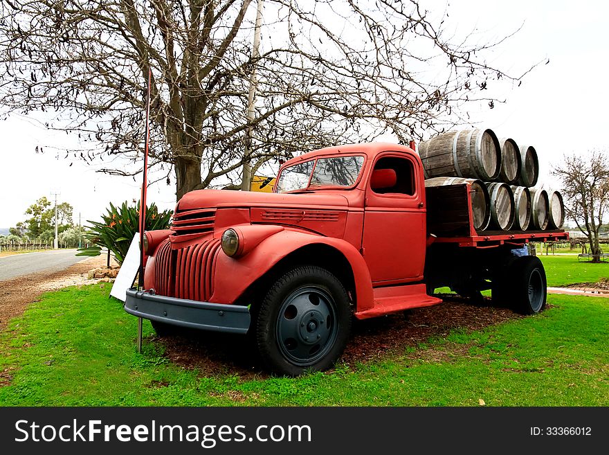 Old red farm truck loaded with barrels. Old red farm truck loaded with barrels.