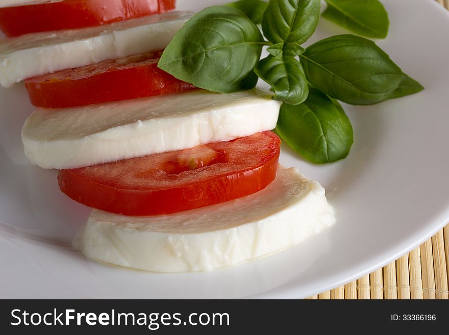 Dish on a white plate of mozzarella tomato basil