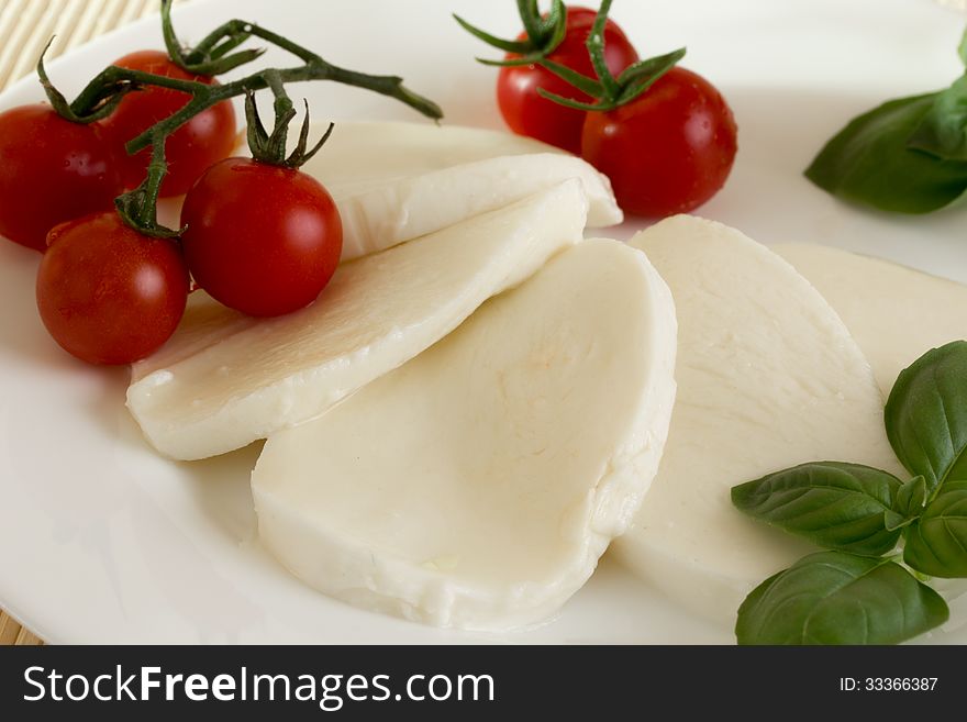 Dish on a white plate of mozzarella tomato basil