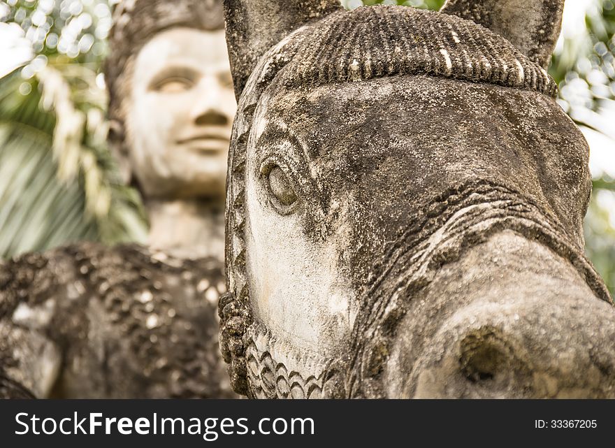 Detail of a knight with horse in the Buddha Park ( Wat Xieng Khuan ) in Vientiane, Laos. Detail of a knight with horse in the Buddha Park ( Wat Xieng Khuan ) in Vientiane, Laos.