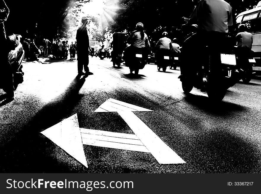 Dramatic frontal view of a pedestrian crossing the street with dangerous traffic. Dramatic frontal view of a pedestrian crossing the street with dangerous traffic.