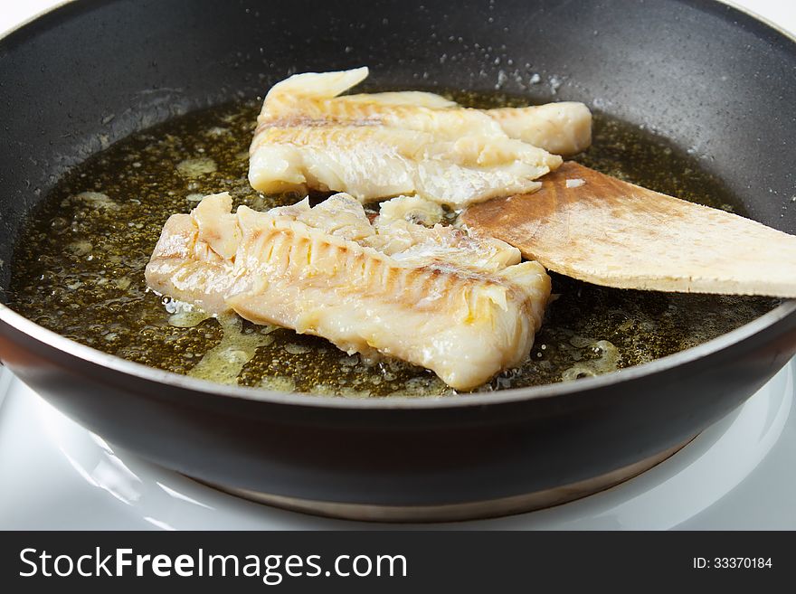 Cooking pollock fillets in frying pan. Cooking pollock fillets in frying pan