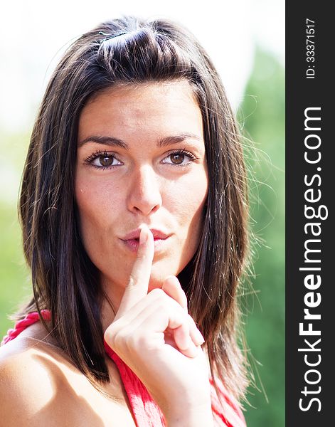 Portrait of misterious girl making silence sign. Portrait of misterious girl making silence sign.