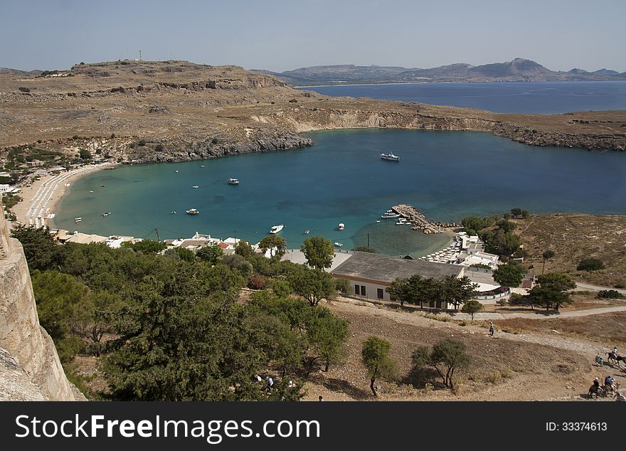 View from above of the main water sea beach in Lindos on the Island of Rhodes Greece photo. Travel concept. View from above of the main water sea beach in Lindos on the Island of Rhodes Greece photo. Travel concept.
