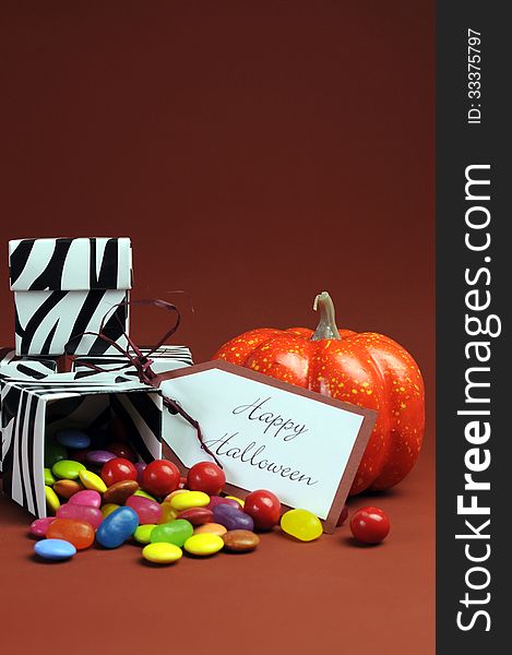 Happy Halloween trick or treat black and white zebra candy boxes with orange pumpkin. Vertical with copy space for your text here. Happy Halloween trick or treat black and white zebra candy boxes with orange pumpkin. Vertical with copy space for your text here.