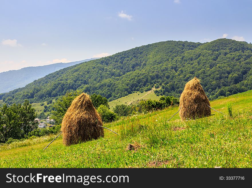 Haystacks on the hillside near the village
