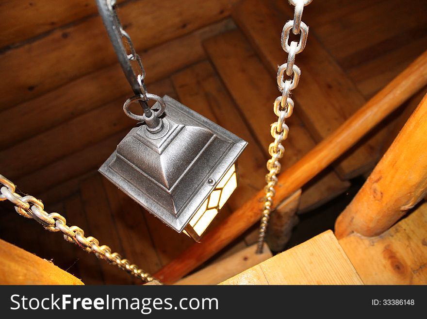 Black lantern with candle that lights the wood stairs. Black lantern with candle that lights the wood stairs