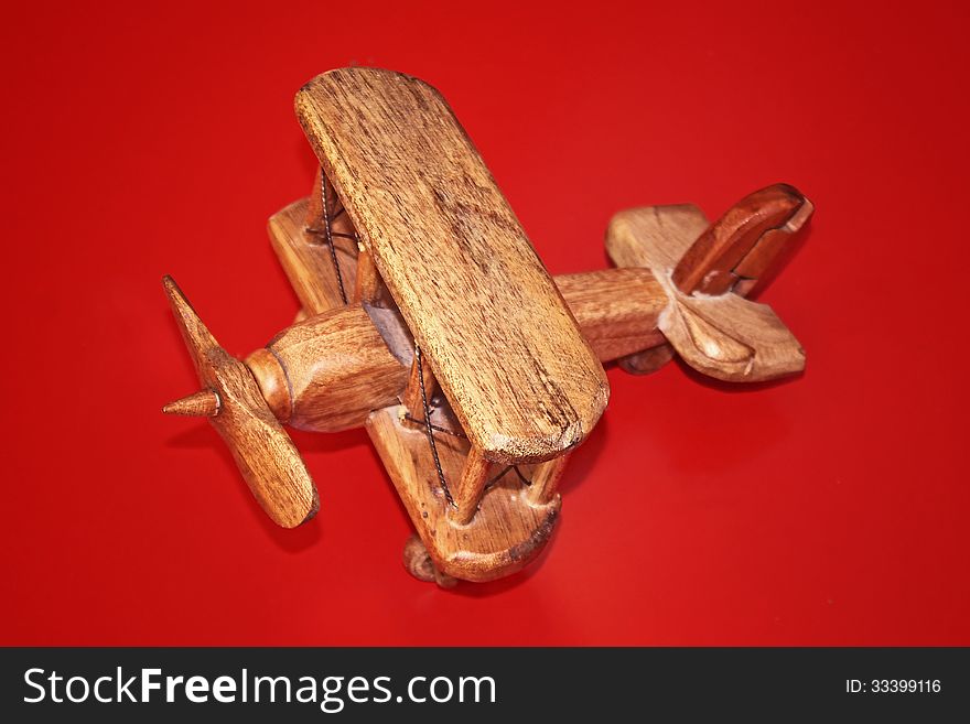 Wooden Toy Plane on a red background