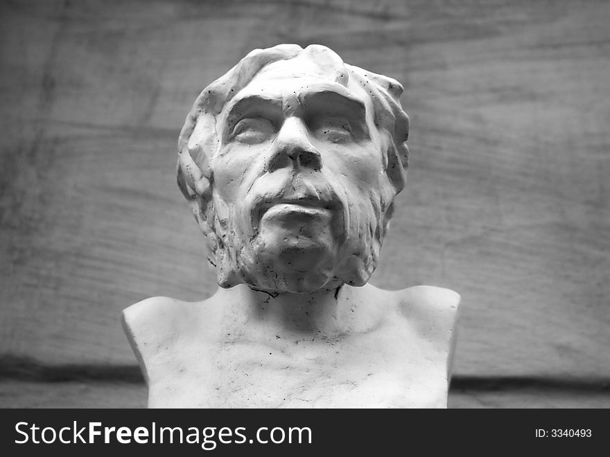 Black and white sculpture of ancient man