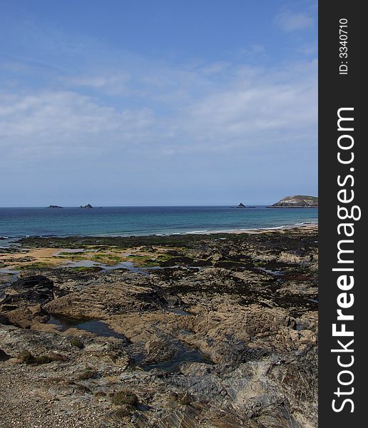 Looking along over rocks to the sea â€“  Constantine Bay, Cornwall, England