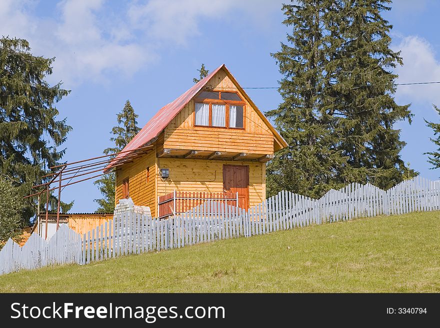 Image of a holiday wooden house in a mountain region.