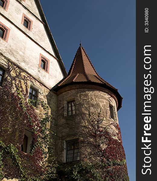 Entwined tower and facade of a German baroque castle. Entwined tower and facade of a German baroque castle