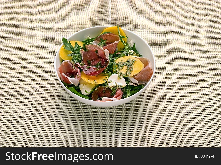 Salad with prosciutto and mango