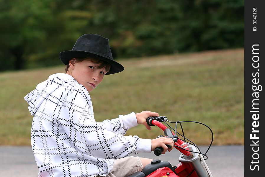 Boy sitting on dirtbike