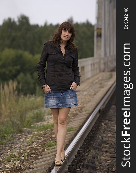 Girl on the railway near forest
