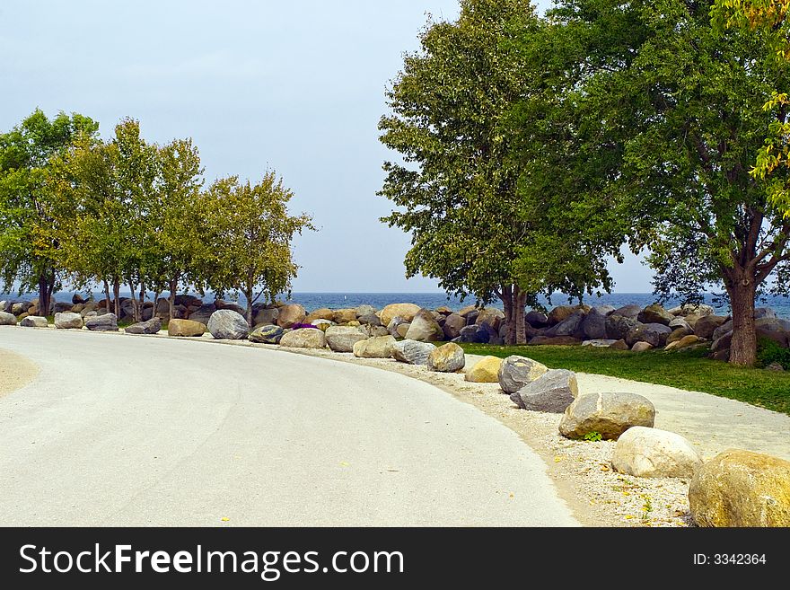 Sidewalk with big rock fence. Sidewalk with big rock fence