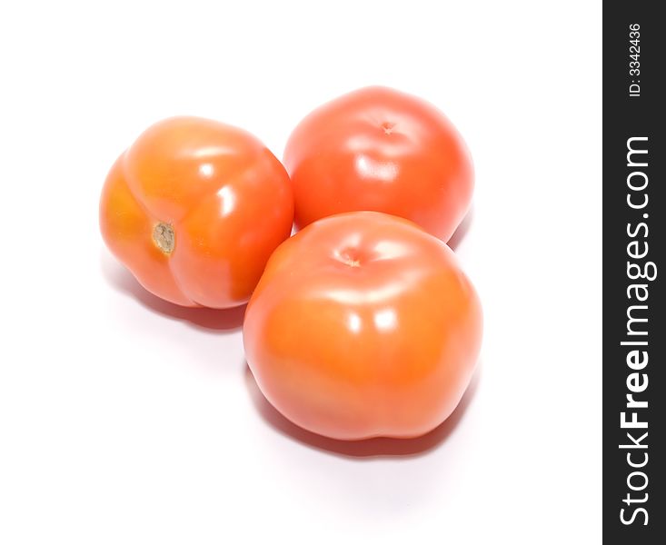 Juicy ripe tomatoes on white. Full isolation on white. Juicy ripe tomatoes on white. Full isolation on white.