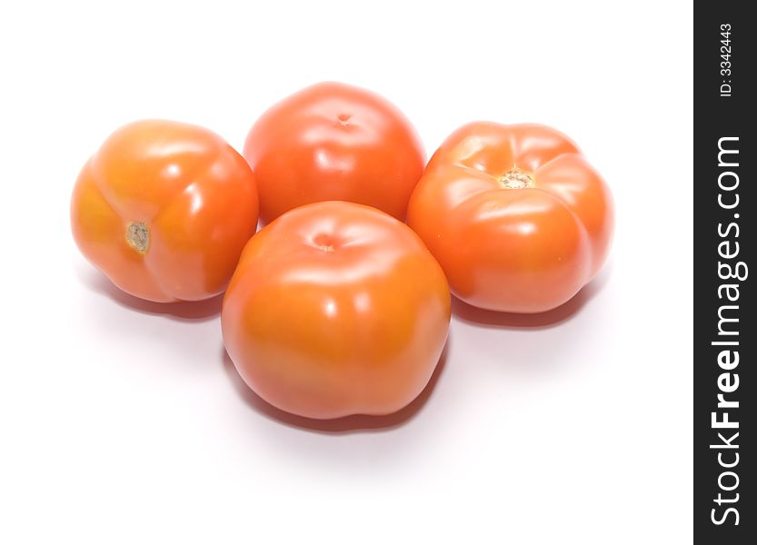 Juicy ripe tomatoes on white. Full isolation on white. Juicy ripe tomatoes on white. Full isolation on white.