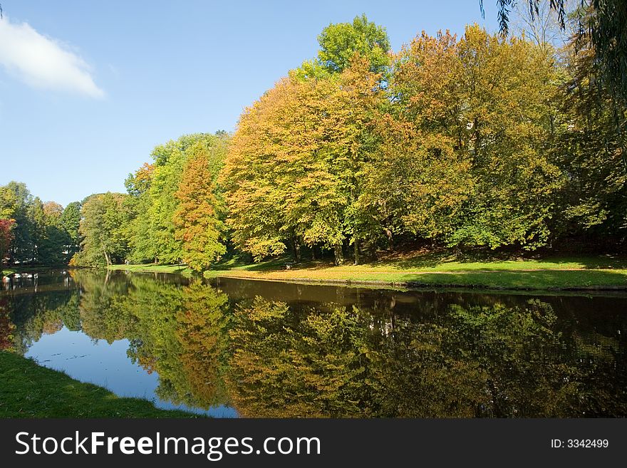 Park landscape with lake in autumn