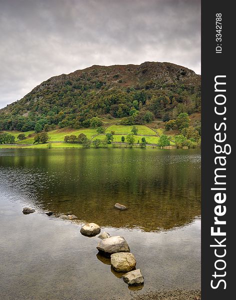 Early Autumn trees reflected in Rydal Water. Early Autumn trees reflected in Rydal Water