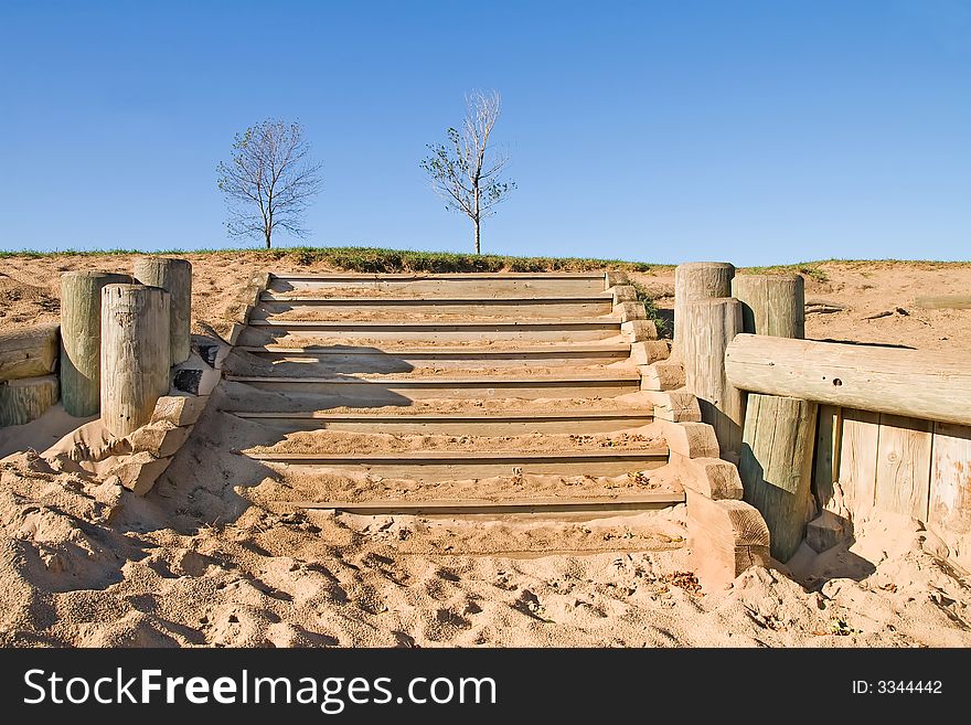 Wood stair steps at the top of a sand dune hill in autumn. Wood stair steps at the top of a sand dune hill in autumn